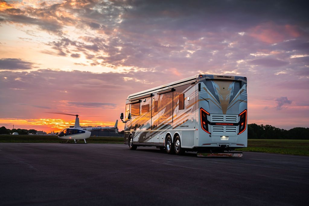 Cornerstone Series 6 coach at sunset beside a helicopter